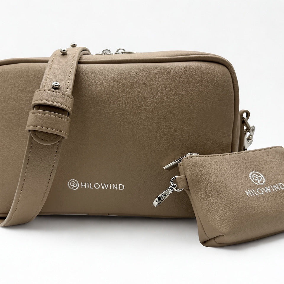 Vorderansicht HILOWIND Gassitasche YUNO in beige mit Kotbeutelspender aus veganem Apfelleder, handgefertigt in Portugal.